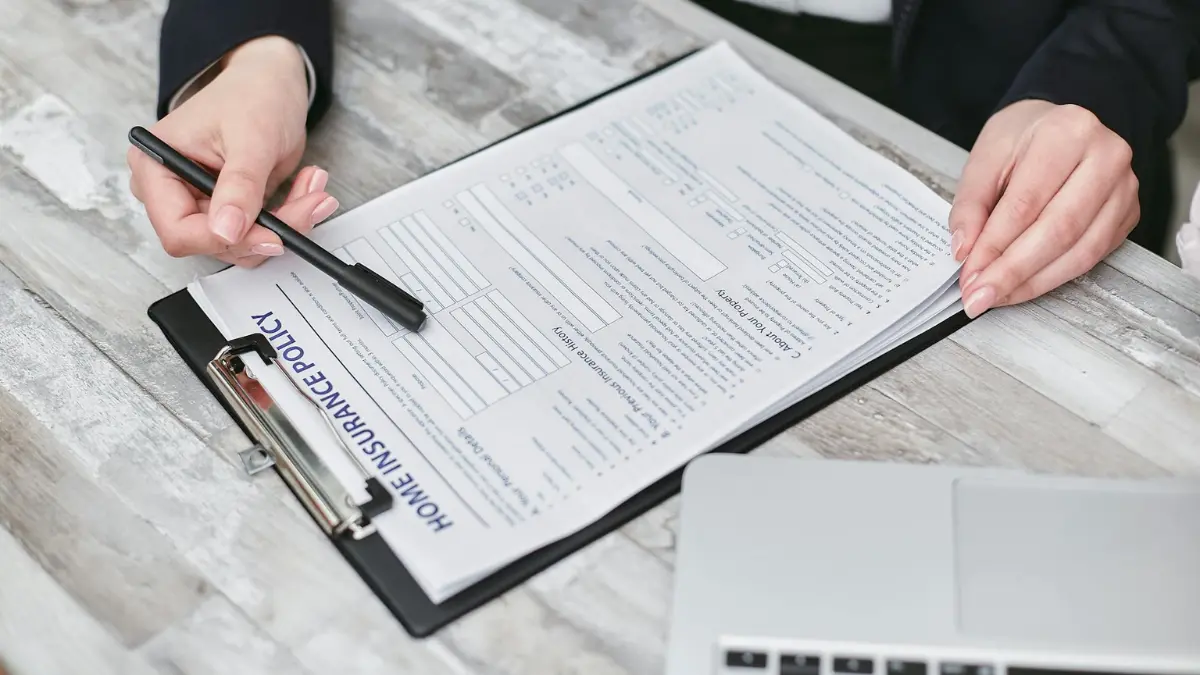Does insurance cover mold remediation — homeowner reviewing insurance policy declarations page to file a mold damage claim