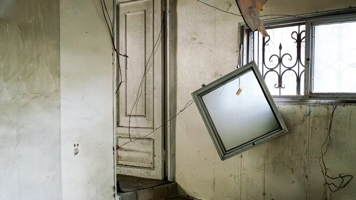 Mold Exposure Symptoms shown in a deteriorating home interior with visible environmental damage and decay.