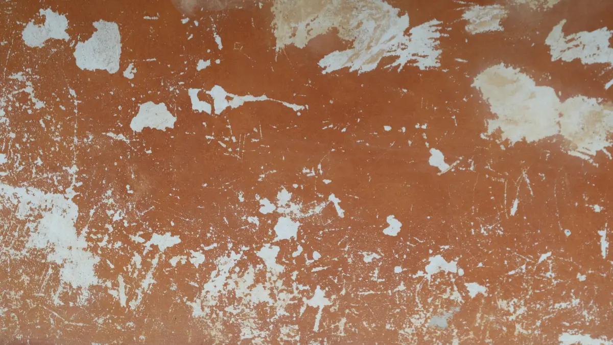 Mold Exposure Symptoms linked to water damage and mold-like discoloration on a chipped interior wall.