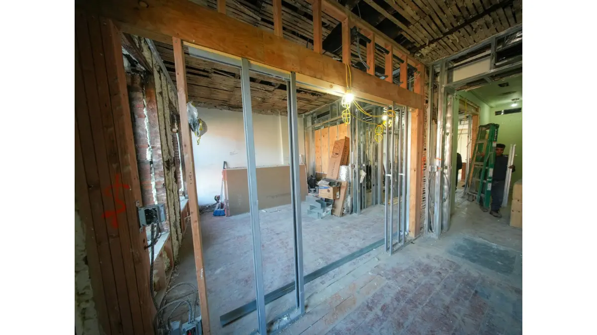 Mold Removal project showing exposed wall framing and structural wood studs during interior repair work.