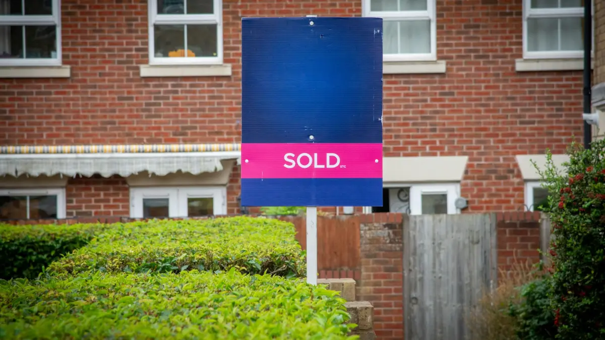 Mold remediation before selling — red sold sign in front of a house proving that homes with disclosed mold can still close successfully.